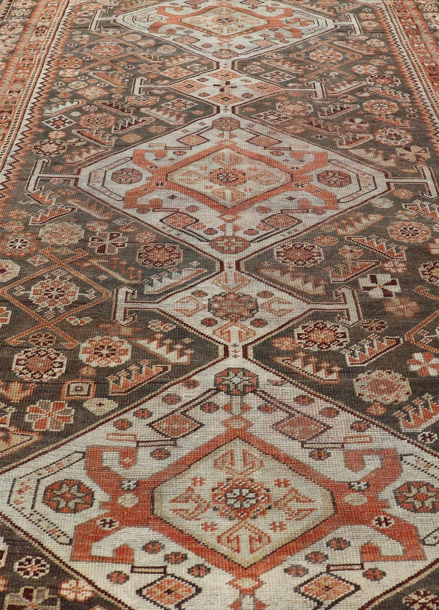 Antique Hand - Knotted Persian Shiraz in Wool with All - Over Medallion Design This antique Persian Shiraz rug has been hand - knotted in wool and features an all - over sub - geometric design rendered in multicolor. A complementary, multi - tiered border ... - Keivan Woven ArtsEMB - 9606 - P13865 - 15649Rug