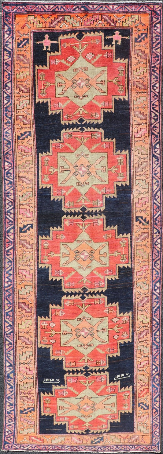 Long Hand - Knotted Antique Persian Azerbaijan Runner in Wool with Medallions This antique Persian Azerbaijan styled runner has been hand - knotted in wool. The rug features a sub - geometric medallion design, and is enclosed within a complementary, ... - Keivan Woven ArtsEMB - 9608 - P13508 - 15661Rug