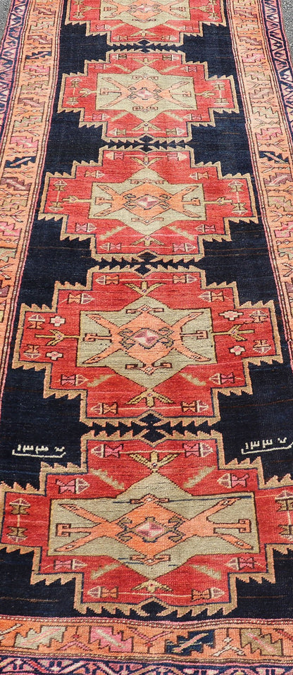 Long Hand - Knotted Antique Persian Azerbaijan Runner in Wool with Medallions This antique Persian Azerbaijan styled runner has been hand - knotted in wool. The rug features a sub - geometric medallion design, and is enclosed within a complementary, ... - Keivan Woven ArtsEMB - 9608 - P13508 - 15661Rug