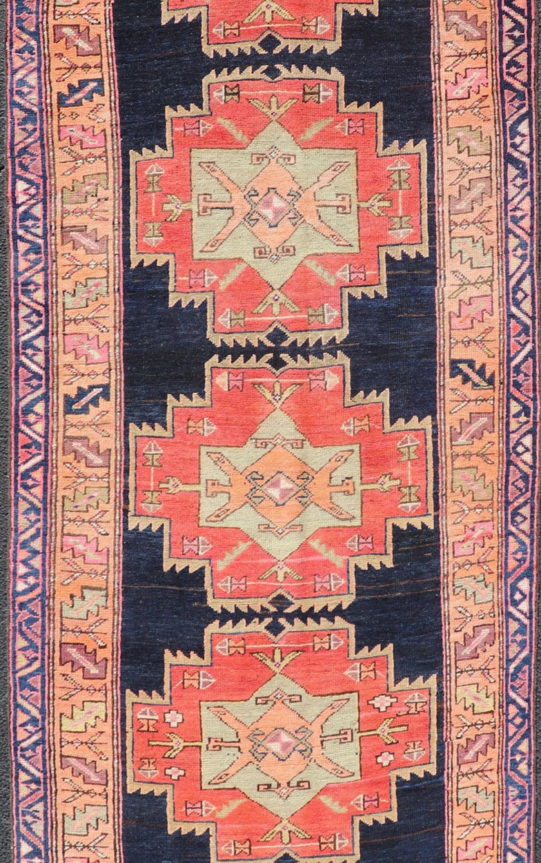Long Hand - Knotted Antique Persian Azerbaijan Runner in Wool with Medallions This antique Persian Azerbaijan styled runner has been hand - knotted in wool. The rug features a sub - geometric medallion design, and is enclosed within a complementary, ... - Keivan Woven ArtsEMB - 9608 - P13508 - 15661Rug