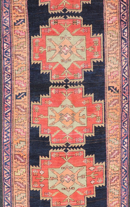 Long Hand - Knotted Antique Persian Azerbaijan Runner in Wool with Medallions This antique Persian Azerbaijan styled runner has been hand - knotted in wool. The rug features a sub - geometric medallion design, and is enclosed within a complementary, ... - Keivan Woven ArtsEMB - 9608 - P13508 - 15661Rug