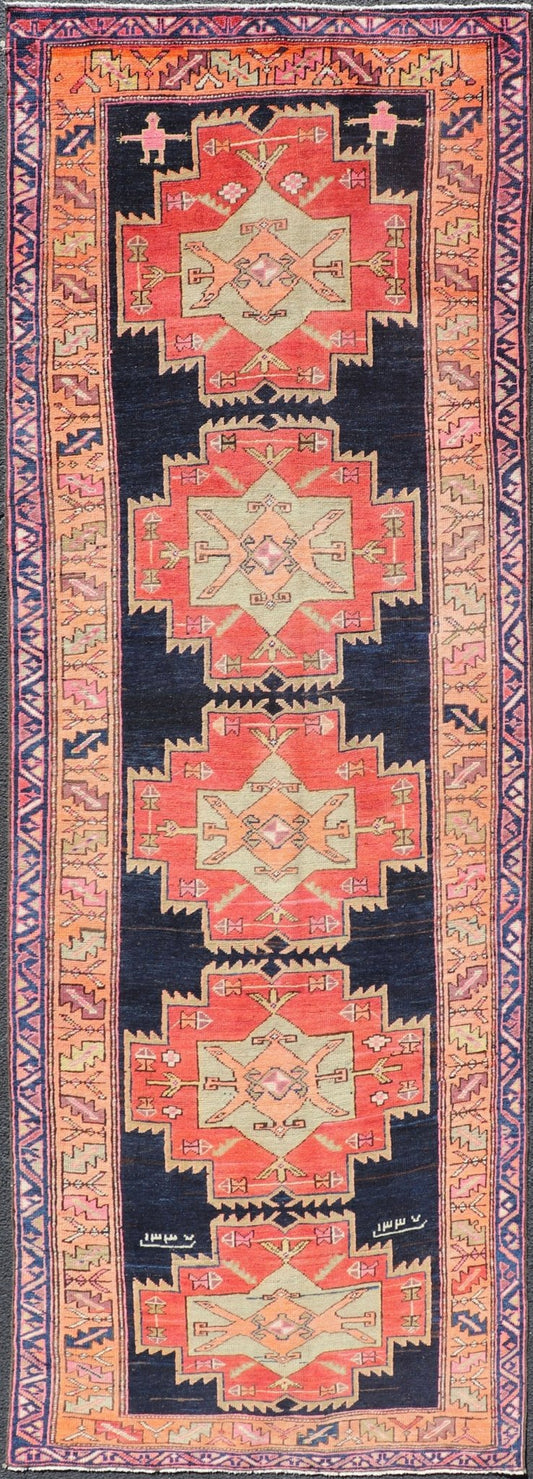 Long Hand - Knotted Antique Persian Azerbaijan Runner in Wool with Medallions This antique Persian Azerbaijan styled runner has been hand - knotted in wool. The rug features a sub - geometric medallion design, and is enclosed within a complementary, ... - Keivan Woven ArtsEMB - 9608 - P13508 - 15661
