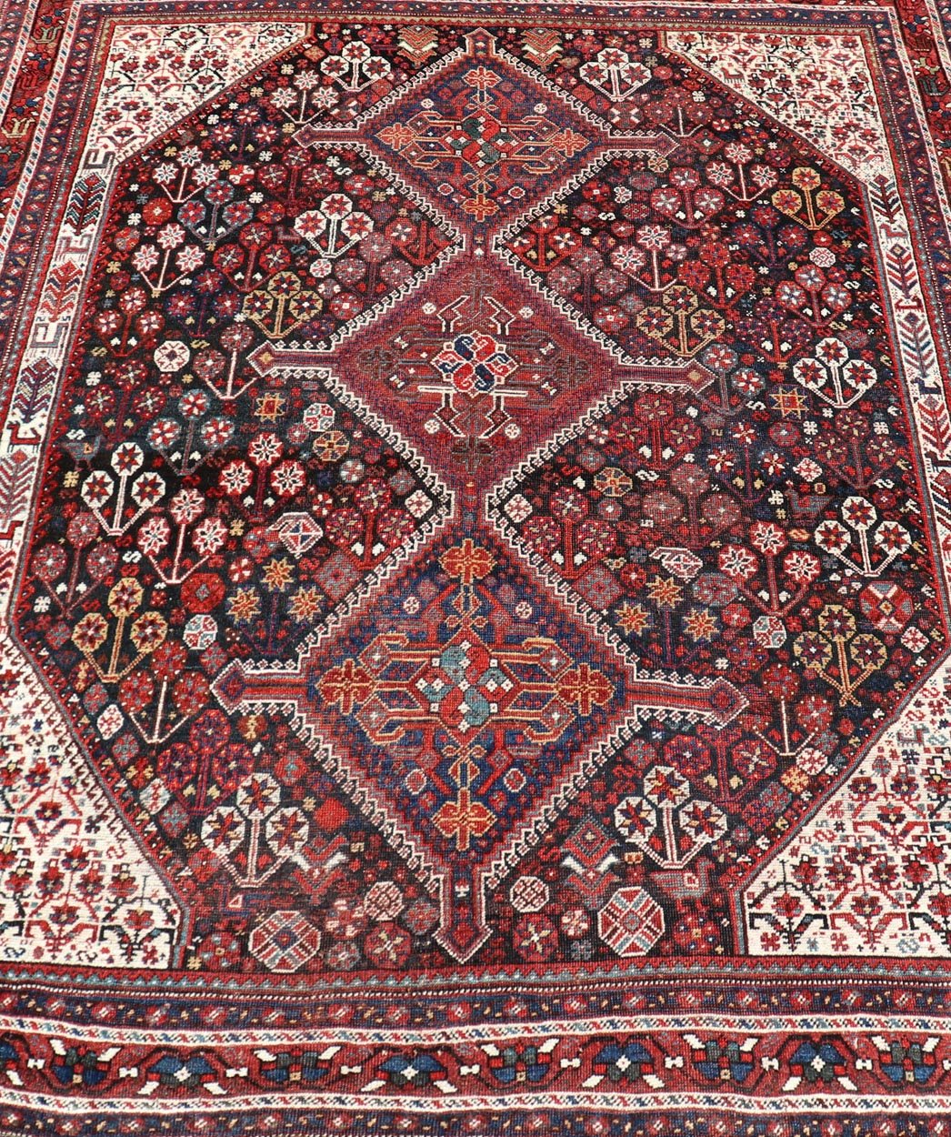 Antique Hand - Knotted Persian Qashqai Rug in Wool with All - Over Tribal Design This antique Persian Qashqai rug has been hand - knotted in wool and features an all - over sub - geometric design rendered in multicolor. A complementary, multi - tiered borde... - Keivan Woven ArtsEMB - 9628 - P13856 - 16007Rug