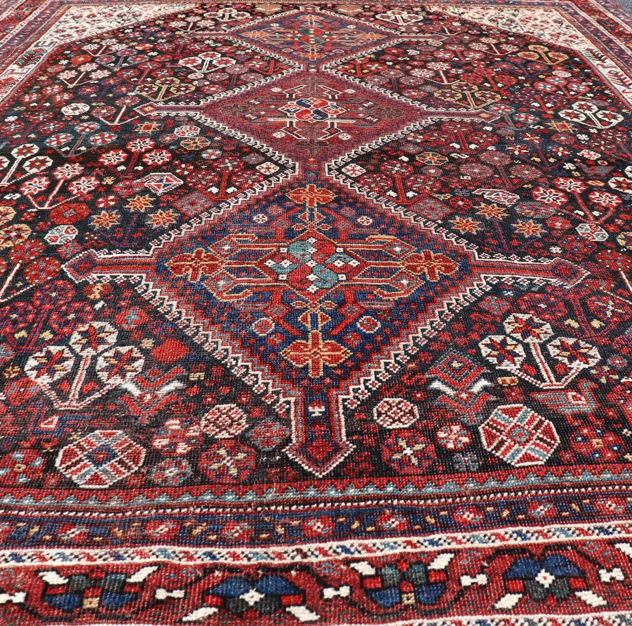 Antique Hand - Knotted Persian Qashqai Rug in Wool with All - Over Tribal Design This antique Persian Qashqai rug has been hand - knotted in wool and features an all - over sub - geometric design rendered in multicolor. A complementary, multi - tiered borde... - Keivan Woven ArtsEMB - 9628 - P13856 - 16007Rug