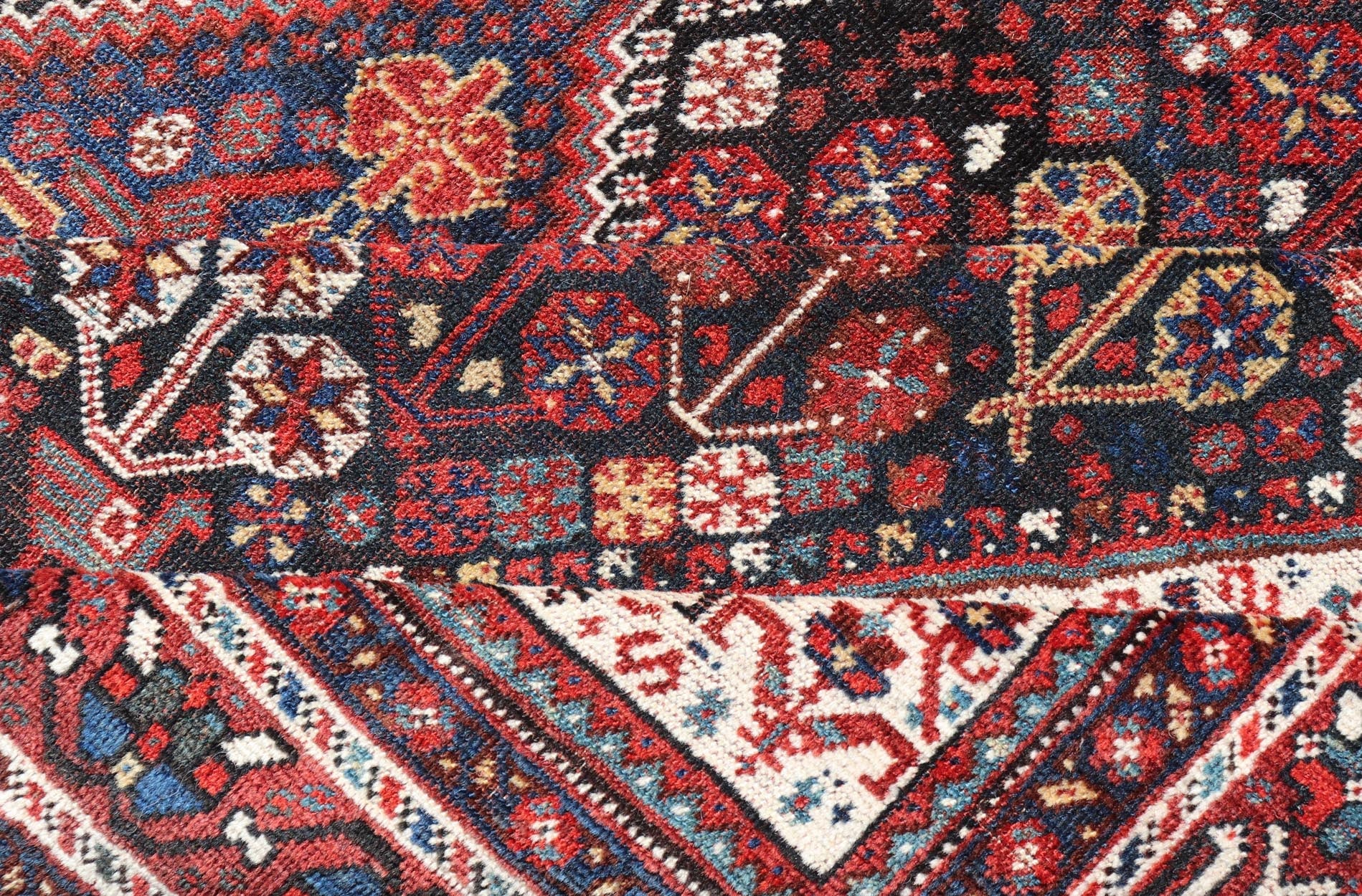 Antique Hand - Knotted Persian Qashqai Rug in Wool with All - Over Tribal Design This antique Persian Qashqai rug has been hand - knotted in wool and features an all - over sub - geometric design rendered in multicolor. A complementary, multi - tiered borde... - Keivan Woven ArtsEMB - 9628 - P13856 - 16007Rug