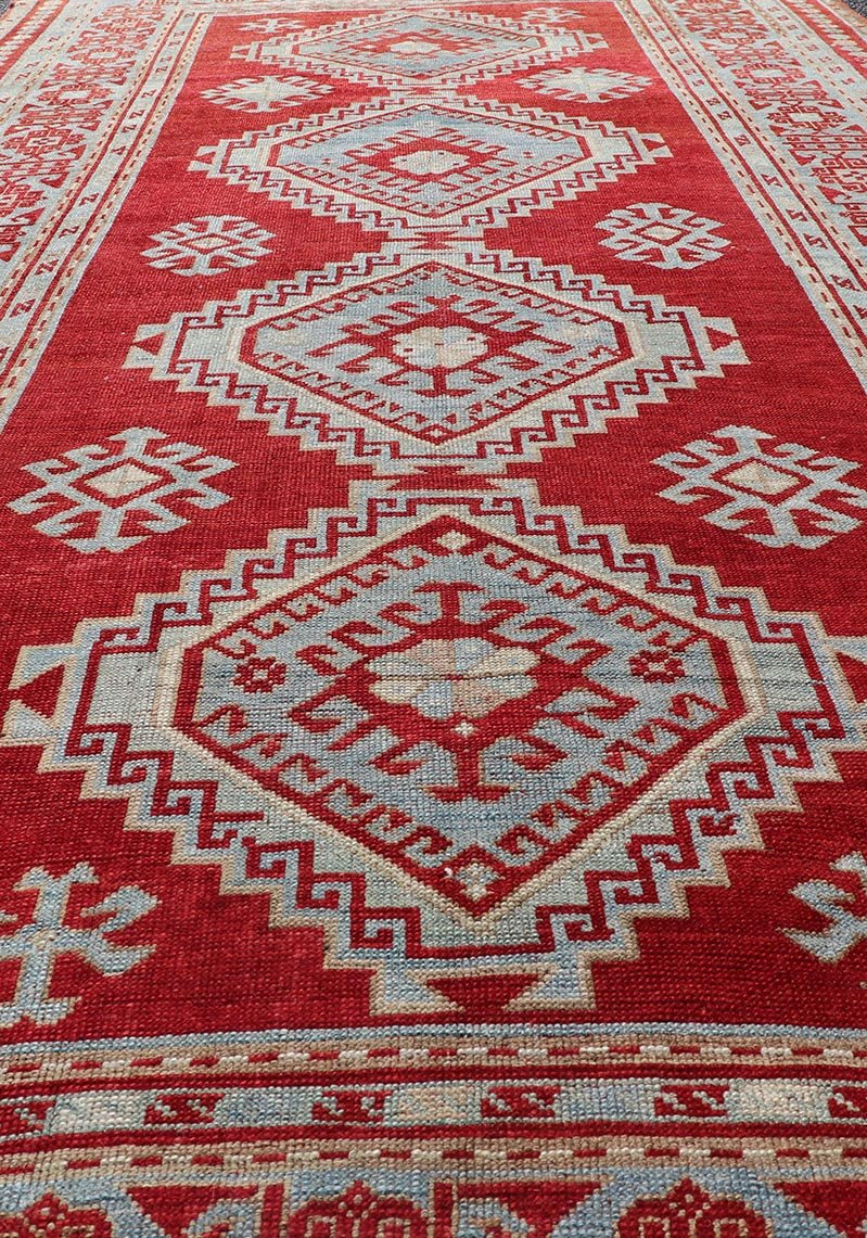 Antique Caucasian Kazak Gallery Rug in Brilliant Red with Geometric Design Tribal geometric medallion design Kazak antique rug, antique Caucasian from Caucasus Region with a beautiful red background in multi - colors, Keivan Woven Arts / rug E... - Keivan Woven ArtsEMB - 9637 - P13567 - 16037Rug