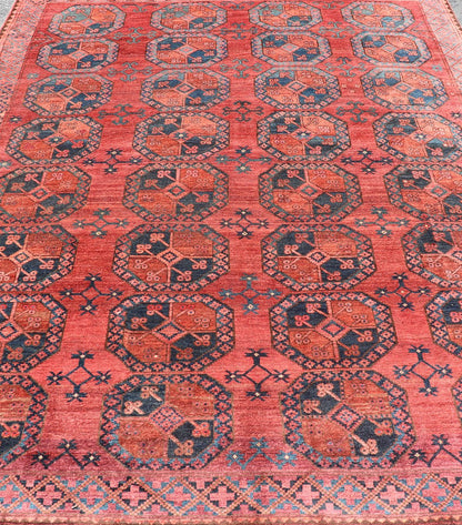 Hand - Knotted Turkomen Ersari Rug in Wool with Gul Design in Red, Orange and Blue This Turkomen Ersari rug has been hand - knotted in the finest wool. The rug features a repeating Gul design throughout the entirety of the rug, enclosed within a co... - Keivan Woven ArtsEMB - 9644 - P13547 - 16073Rug