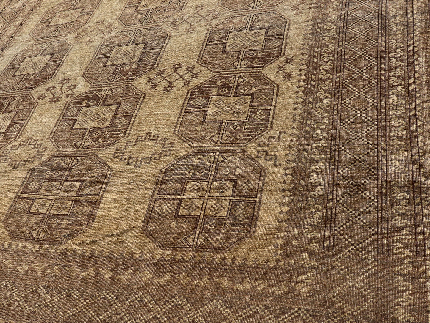 Hand - Knotted Turkomen Ersari Rug in Wool with Gul Design in Brown, Tan and Taupe This Turkomen Ersari rug has been hand - knotted in the finest wool. The rug features an all - over repeating Gul design throughout the entirety of the rug, enclosed w... - Keivan Woven ArtsEMB - 9647 - P13549 - 16091Rug