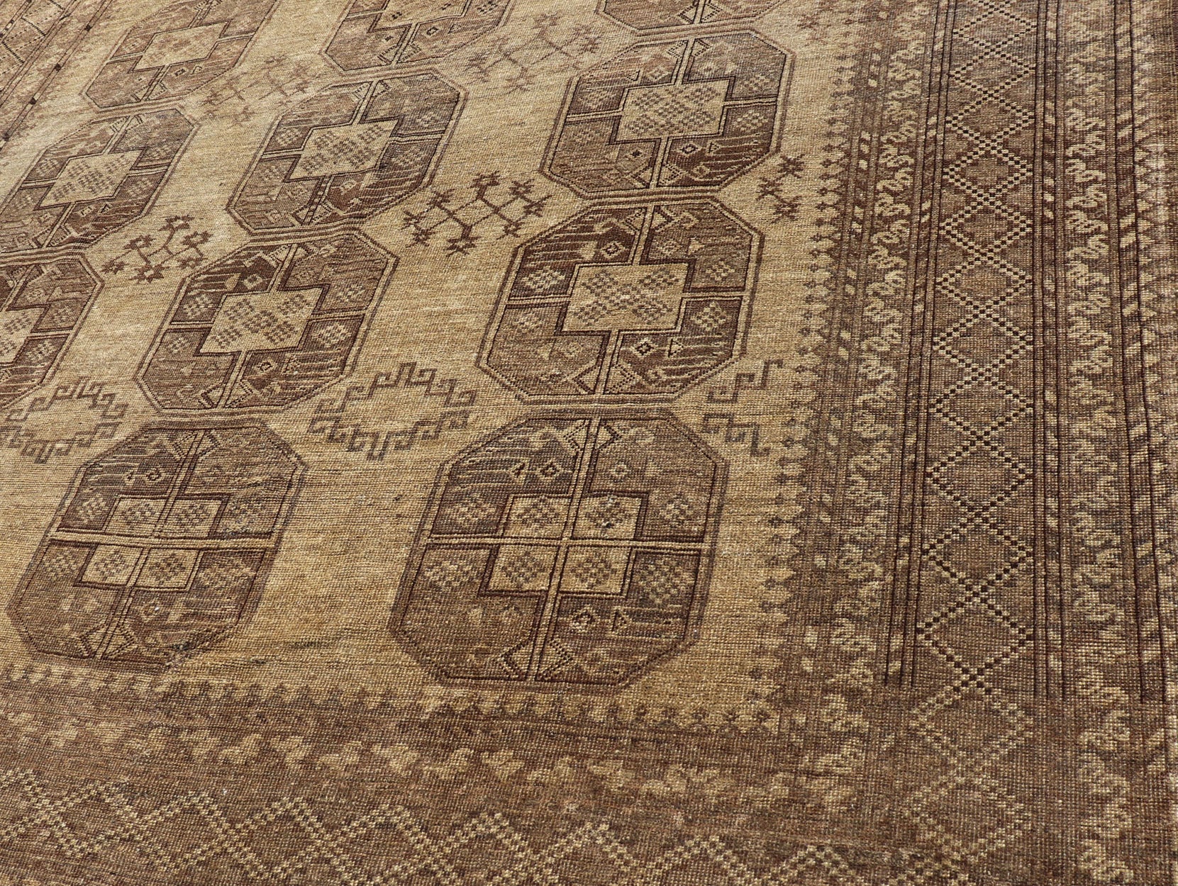 Hand - Knotted Turkomen Ersari Rug in Wool with Gul Design in Brown, Tan and Taupe This Turkomen Ersari rug has been hand - knotted in the finest wool. The rug features an all - over repeating Gul design throughout the entirety of the rug, enclosed w... - Keivan Woven ArtsEMB - 9647 - P13549 - 16091Rug