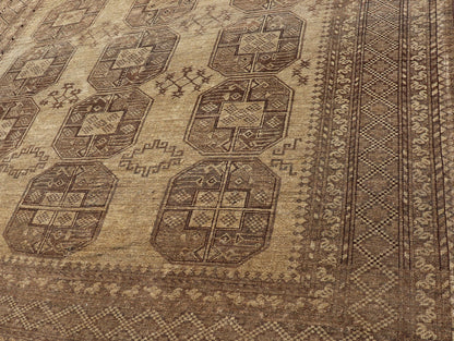 Hand - Knotted Turkomen Ersari Rug in Wool with Gul Design in Brown, Tan and Taupe This Turkomen Ersari rug has been hand - knotted in the finest wool. The rug features an all - over repeating Gul design throughout the entirety of the rug, enclosed w... - Keivan Woven ArtsEMB - 9647 - P13549 - 16091Rug