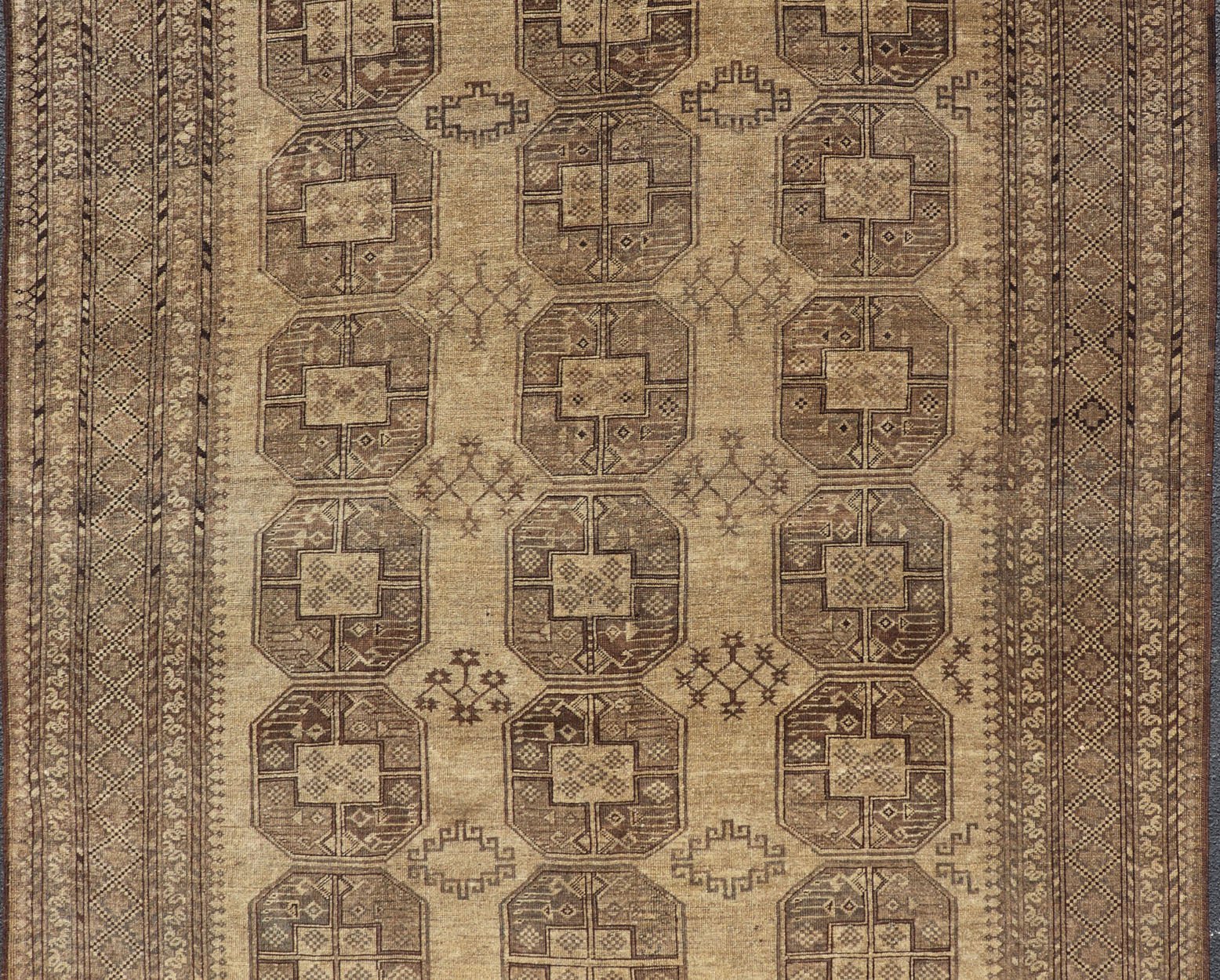 Hand - Knotted Turkomen Ersari Rug in Wool with Gul Design in Brown, Tan and Taupe This Turkomen Ersari rug has been hand - knotted in the finest wool. The rug features an all - over repeating Gul design throughout the entirety of the rug, enclosed w... - Keivan Woven ArtsEMB - 9647 - P13549 - 16091Rug