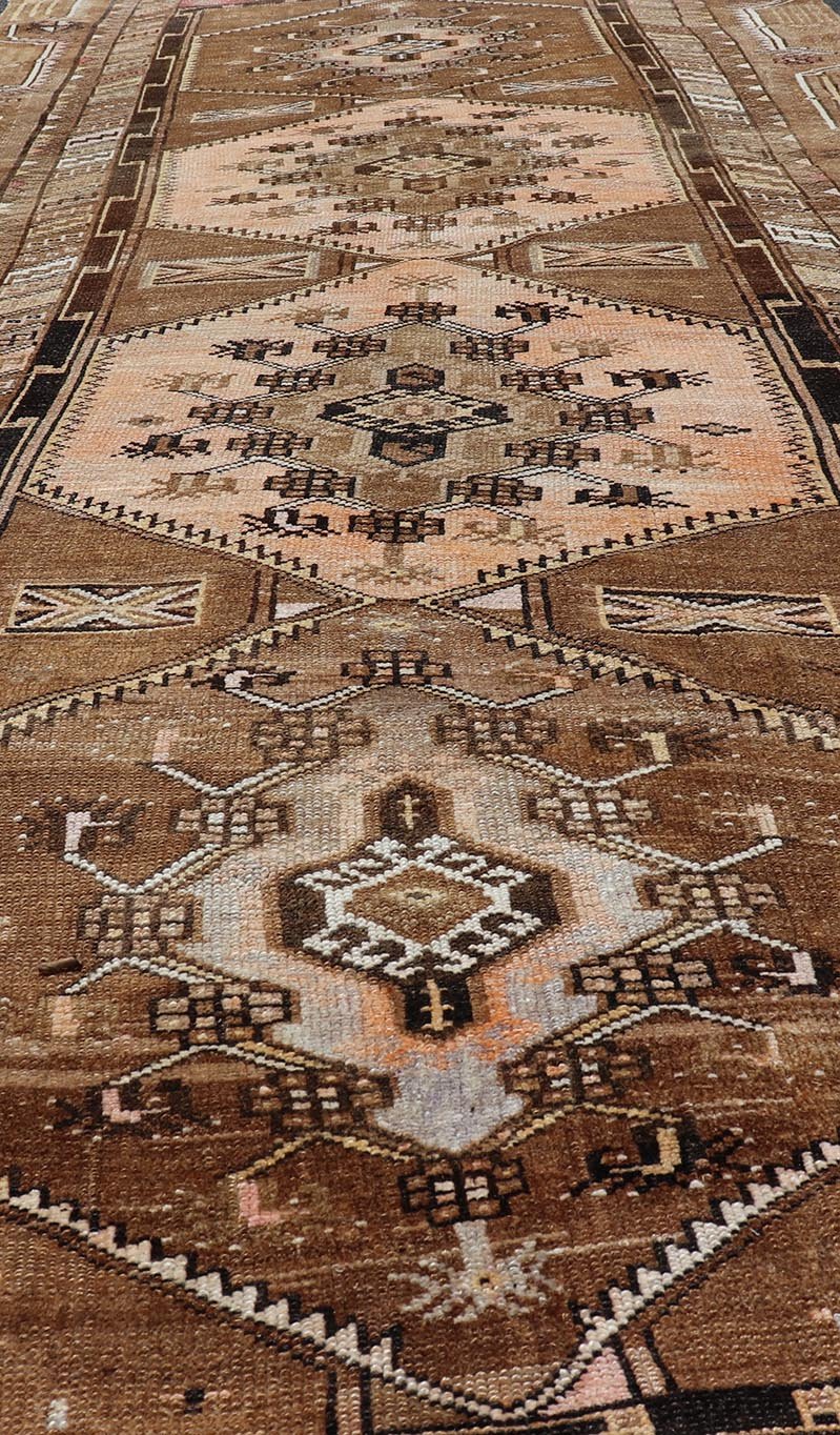 Vintage Hand - Knotted Turkish Kars Galley Rug in Wool with Medallion Design This vintage Turkish Kars gallery rug has been hand - knotted in wool and features a sub - geometric medallion design rendered in multicolor. A complementary, multi - tiered b... - Keivan Woven ArtsEMB - 9676 - P13554 - 16229Rug