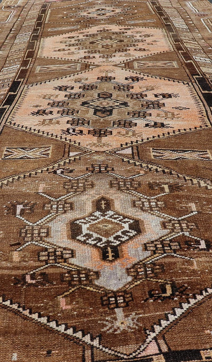 Vintage Hand - Knotted Turkish Kars Galley Rug in Wool with Medallion Design This vintage Turkish Kars gallery rug has been hand - knotted in wool and features a sub - geometric medallion design rendered in multicolor. A complementary, multi - tiered b... - Keivan Woven ArtsEMB - 9676 - P13554 - 16229Rug