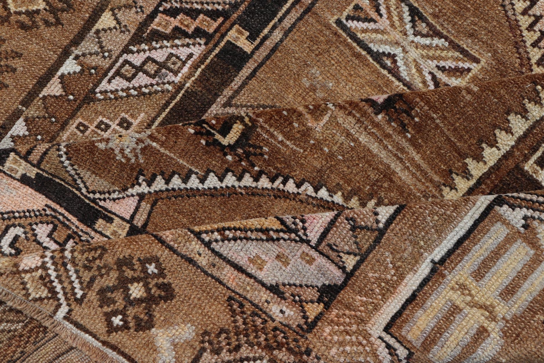 Vintage Hand - Knotted Turkish Kars Galley Rug in Wool with Medallion Design This vintage Turkish Kars gallery rug has been hand - knotted in wool and features a sub - geometric medallion design rendered in multicolor. A complementary, multi - tiered b... - Keivan Woven ArtsEMB - 9676 - P13554 - 16229Rug