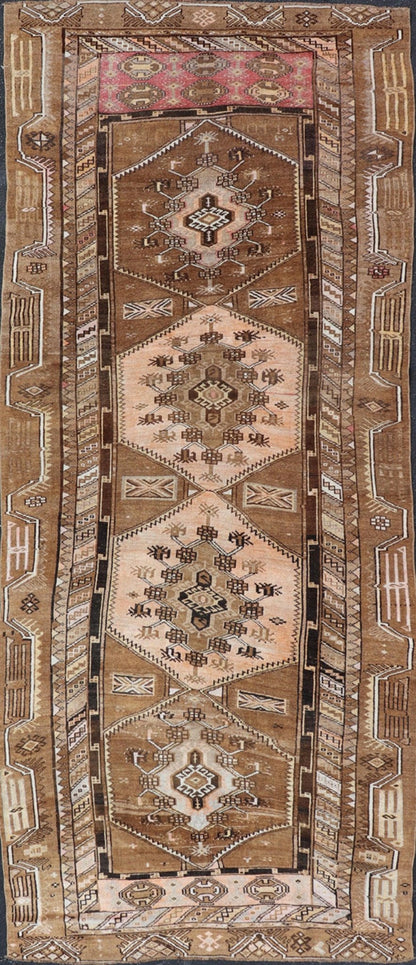 Vintage Hand - Knotted Turkish Kars Galley Rug in Wool with Medallion Design This vintage Turkish Kars gallery rug has been hand - knotted in wool and features a sub - geometric medallion design rendered in multicolor. A complementary, multi - tiered b... - Keivan Woven ArtsEMB - 9676 - P13554 - 16229Rug