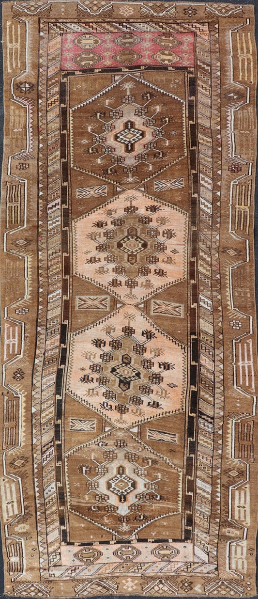 Vintage Hand - Knotted Turkish Kars Galley Rug in Wool with Medallion Design This vintage Turkish Kars gallery rug has been hand - knotted in wool and features a sub - geometric medallion design rendered in multicolor. A complementary, multi - tiered b... - Keivan Woven ArtsEMB - 9676 - P13554 - 16229Rug