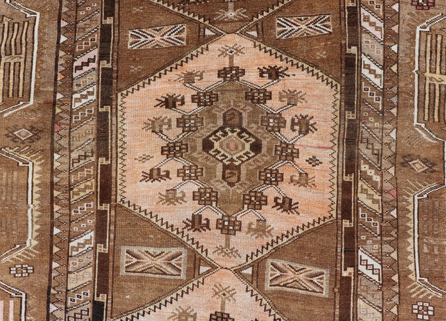 Vintage Hand - Knotted Turkish Kars Galley Rug in Wool with Medallion Design This vintage Turkish Kars gallery rug has been hand - knotted in wool and features a sub - geometric medallion design rendered in multicolor. A complementary, multi - tiered b... - Keivan Woven ArtsEMB - 9676 - P13554 - 16229Rug