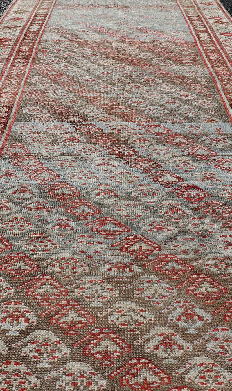 Antique Kurdish Runner in Soft Tones in Wool with Sub - Geometric Paisley Design. Keivan Woven Arts / rug EMB - 9682 - P13585, country of origin / type: Iran / kurdish, circa 1900. This antique Persian Kurdish runner has been hand - knotted in wool and ... - Keivan Woven ArtsEMB - 9682 - P13585 - 16265Rug