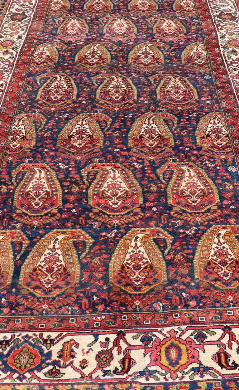 Antique Persian Paisley Field Hamadan in Multi - Tiered Border in Red and Blue This unique Persian Hamadan features a dark blue background placed behind a sub - geometric, red and mustard paisley design. The boldened border highlights ivory between... - Keivan Woven ArtsEMB - 9683 - P13868 - 16271Rug