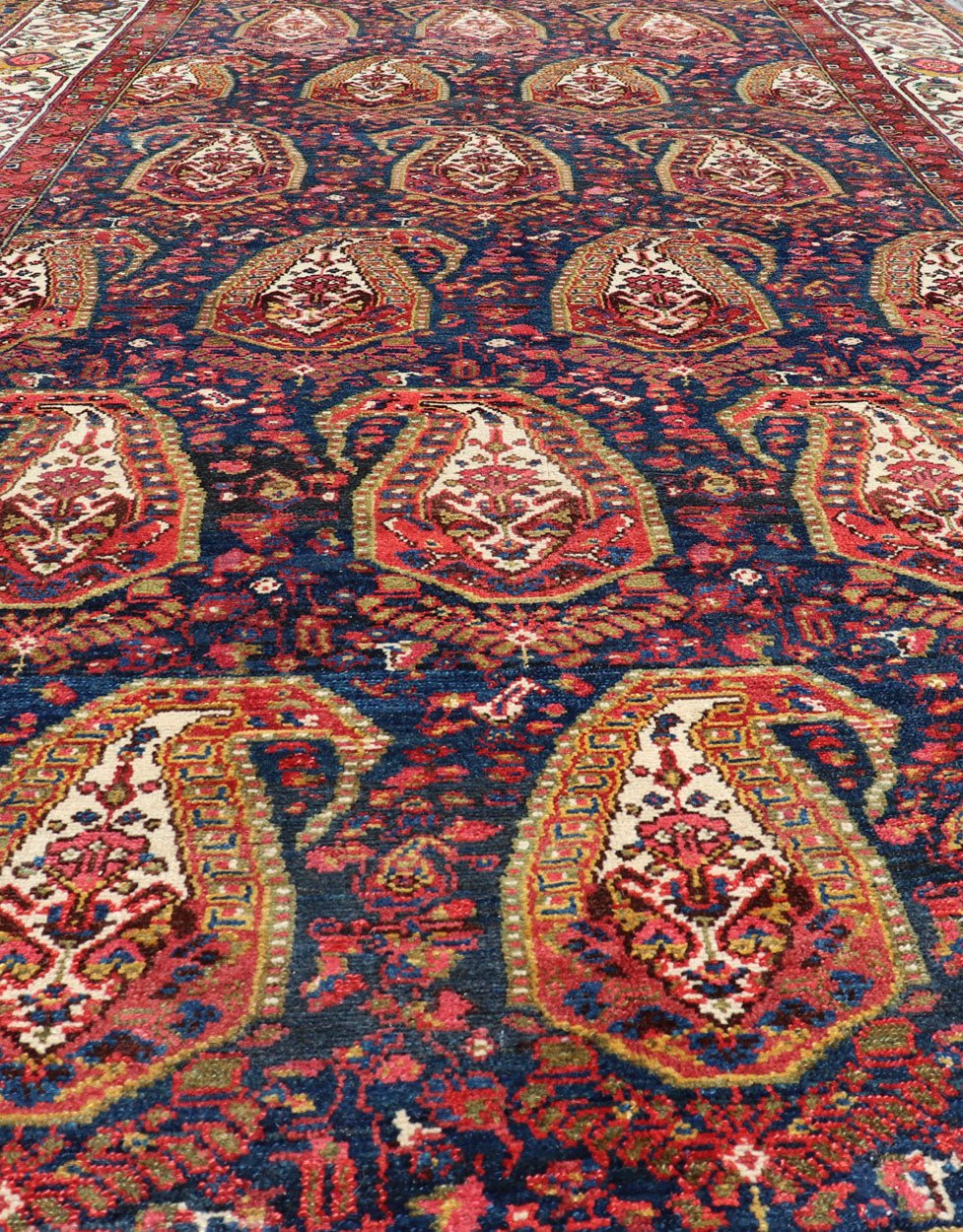 Antique Persian Paisley Field Hamadan in Multi - Tiered Border in Red and Blue This unique Persian Hamadan features a dark blue background placed behind a sub - geometric, red and mustard paisley design. The boldened border highlights ivory between... - Keivan Woven ArtsEMB - 9683 - P13868 - 16271Rug