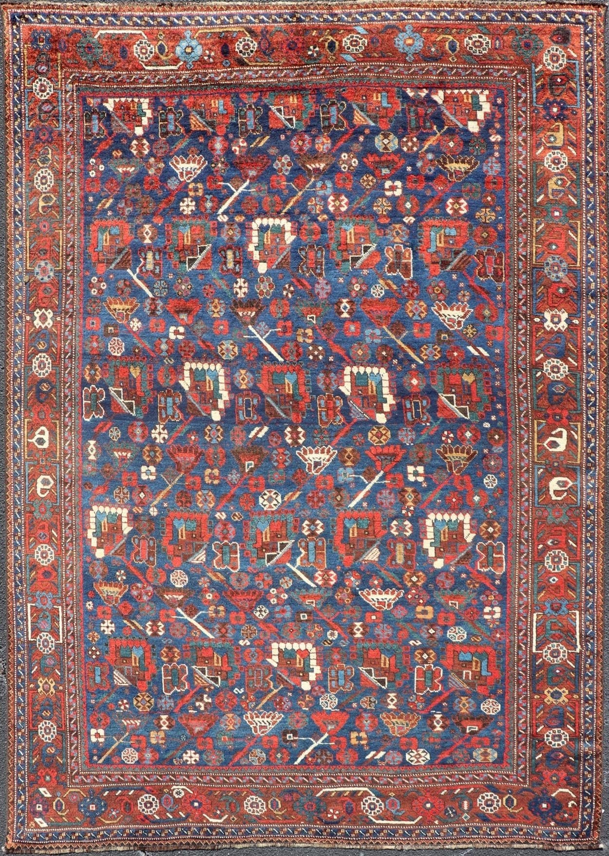 Antique Persian Qashqai Shiraz Tribal Rug with All - Over Tribal Design Antique Persian Qashqai Shiraz Tribal Rug with Tribal Design in jewel tones with blue background. Keivan Woven Arts / rug EMB - 9687 - P13529, country of origin / type: Iran / Qas... - Keivan Woven ArtsEMB - 9687 - P13529 - 16289