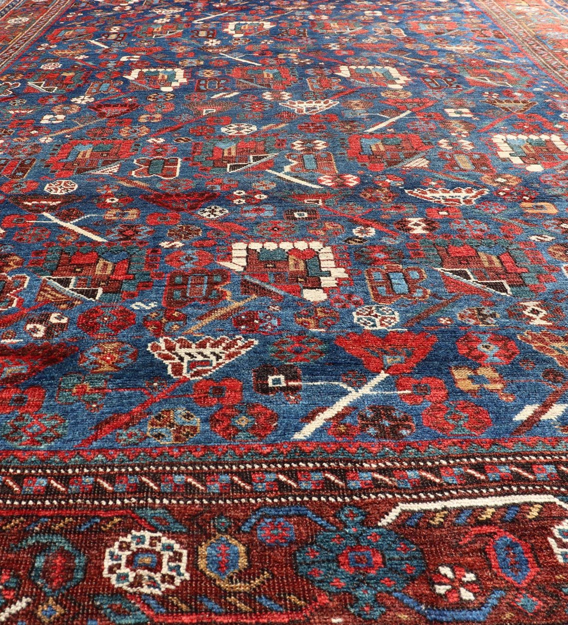 Antique Persian Qashqai Shiraz Tribal Rug with All - Over Tribal Design Antique Persian Qashqai Shiraz Tribal Rug with Tribal Design in jewel tones with blue background. Keivan Woven Arts / rug EMB - 9687 - P13529, country of origin / type: Iran / Qas... - Keivan Woven ArtsEMB - 9687 - P13529 - 16289Rug