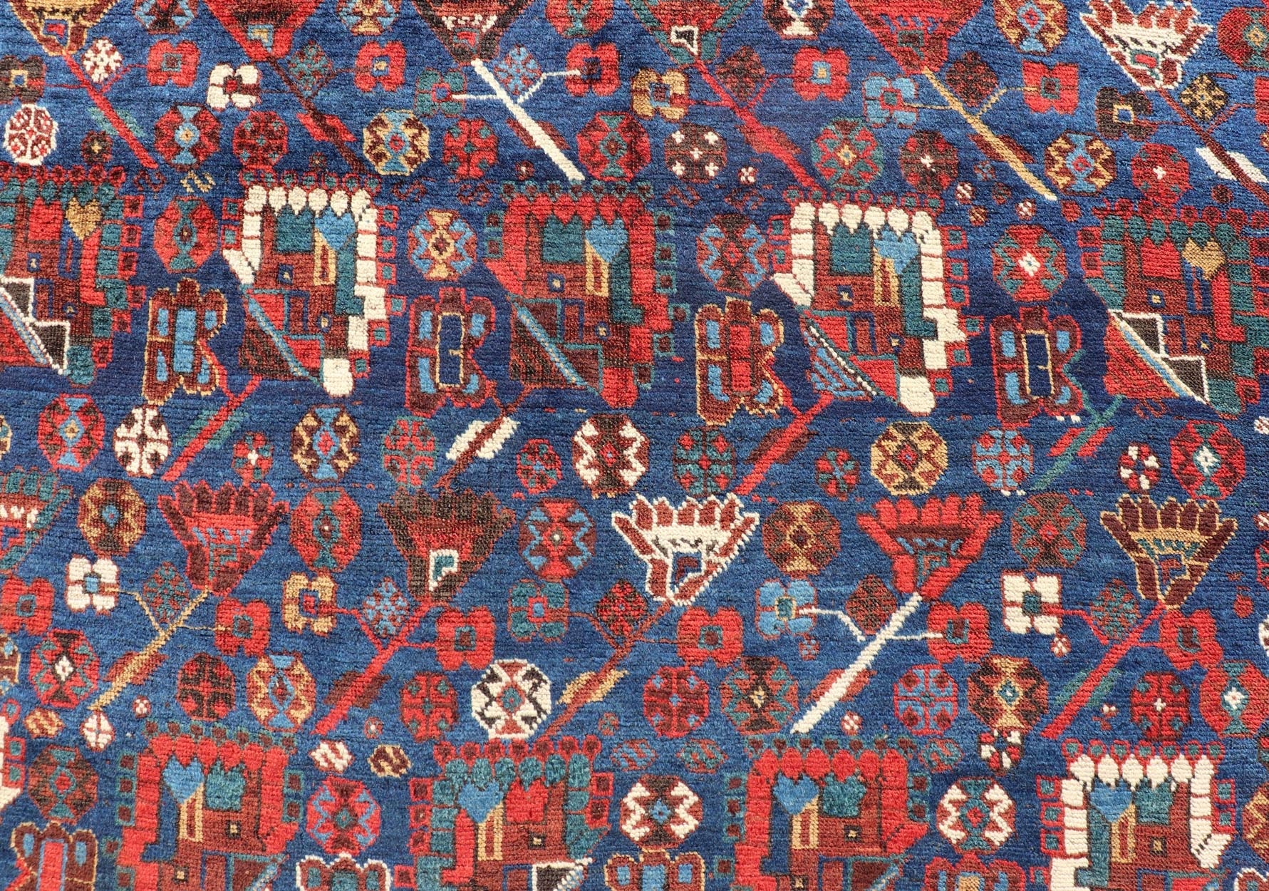 Antique Persian Qashqai Shiraz Tribal Rug with All - Over Tribal Design Antique Persian Qashqai Shiraz Tribal Rug with Tribal Design in jewel tones with blue background. Keivan Woven Arts / rug EMB - 9687 - P13529, country of origin / type: Iran / Qas... - Keivan Woven ArtsEMB - 9687 - P13529 - 16289Rug