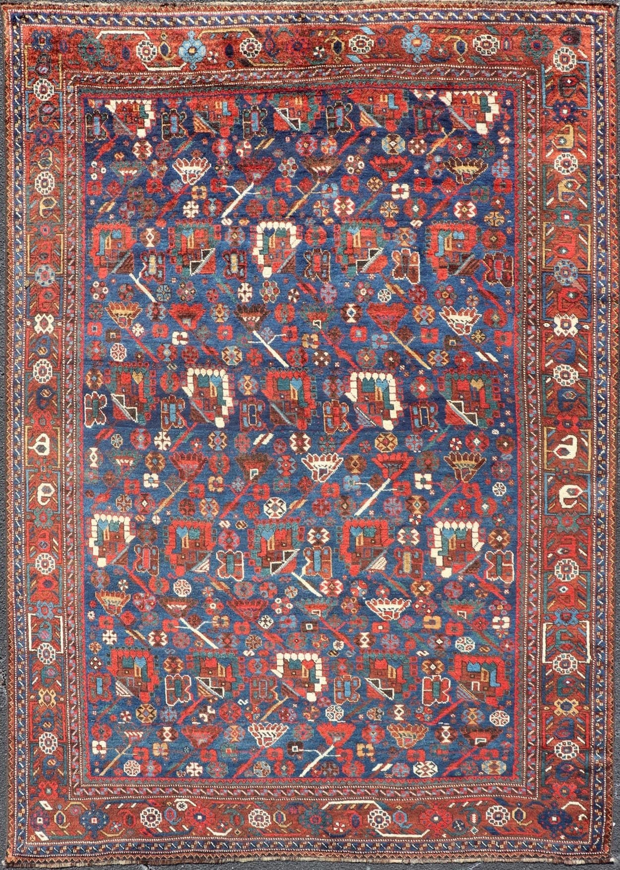 Antique Persian Qashqai Shiraz Tribal Rug with All - Over Tribal Design Antique Persian Qashqai Shiraz Tribal Rug with Tribal Design in jewel tones with blue background. Keivan Woven Arts / rug EMB - 9687 - P13529, country of origin / type: Iran / Qas... - Keivan Woven ArtsEMB - 9687 - P13529 - 16289Rug