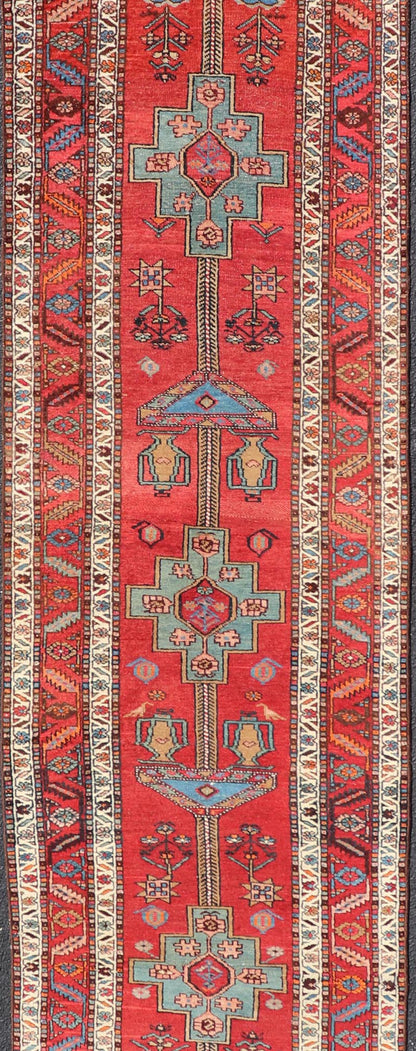Antique Persian Long Persian Serapi Runner in Wool with Medallion Design This antique Persian Serapi rug was hand - knotted in wool and features a sub - geometric medallion design rendered in multicolor. A complementary, multi - tiered border encompas... - Keivan Woven ArtsEMB - 9691 - P13533 - 16313Rug