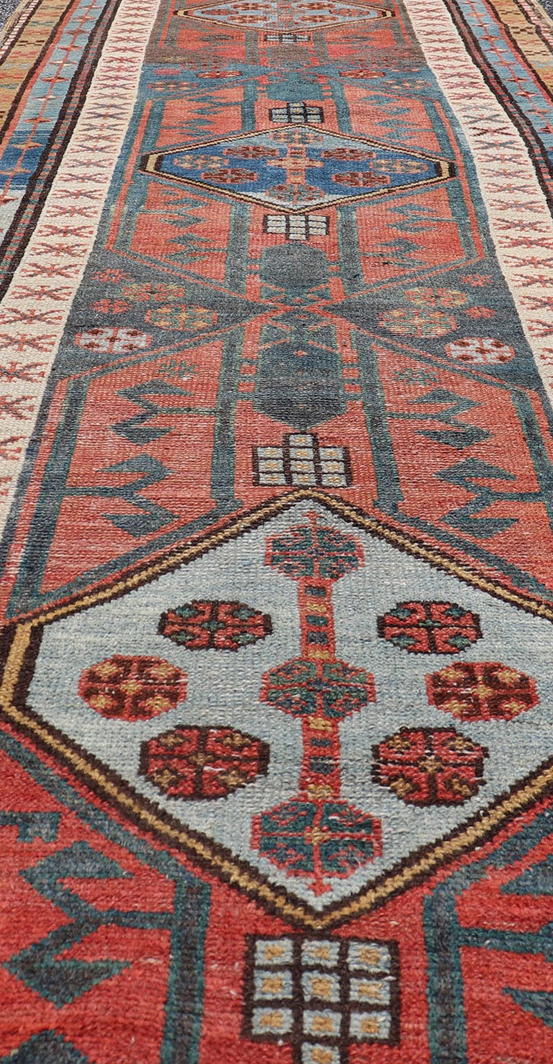 Antique Colorful Persian Heriz - Serapi Runner with a Bold Geometric Design Antique Colorful Persian Heriz - Serapi Runner with a Bold Geometric Design, Keivan Woven Arts / Rug/EMB - 9693 - P13532 Made in the early 20th century, this charming Heriz - ... - Keivan Woven ArtsEMB - 9693 - P13532 - 16319Rug