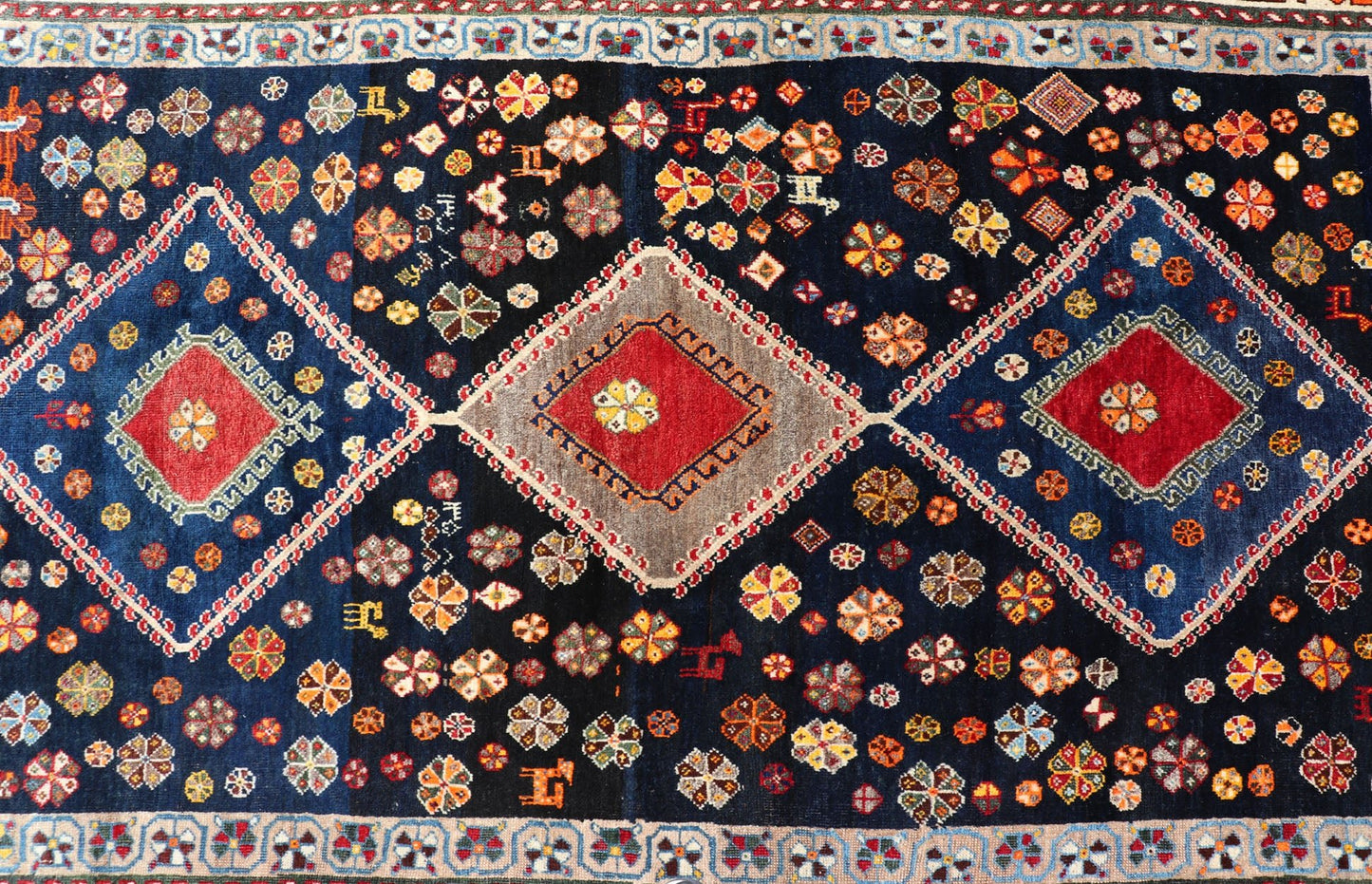 Vintage Persian Tribal Shiraz with Medallion Design on Dark Background This vintage Persian Shiraz features a rich navy blue background under the centered red medallions, edged with green, gold, taupe, maroon, pinks and reds. Paired with ea... - Keivan Woven ArtsEMB - 9694 - P13894 - 16510Rug