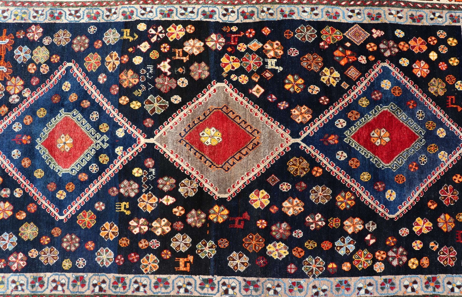 Vintage Persian Tribal Shiraz with Medallion Design on Dark Background This vintage Persian Shiraz features a rich navy blue background under the centered red medallions, edged with green, gold, taupe, maroon, pinks and reds. Paired with ea... - Keivan Woven ArtsEMB - 9694 - P13894 - 16510Rug