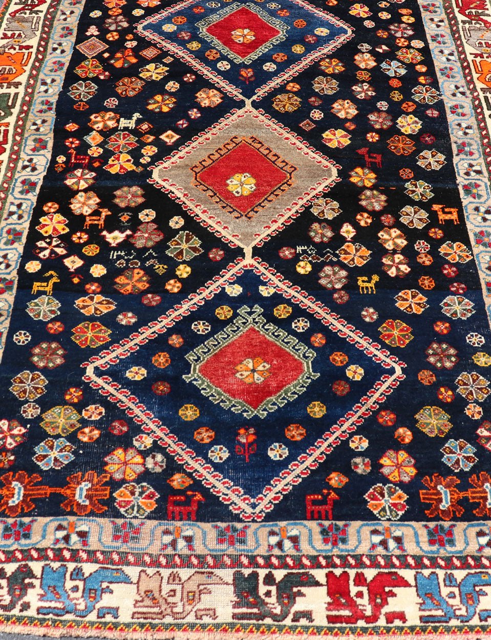 Vintage Persian Tribal Shiraz with Medallion Design on Dark Background This vintage Persian Shiraz features a rich navy blue background under the centered red medallions, edged with green, gold, taupe, maroon, pinks and reds. Paired with ea... - Keivan Woven ArtsEMB - 9694 - P13894 - 16510Rug