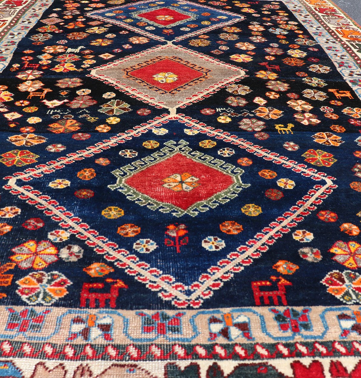 Vintage Persian Tribal Shiraz with Medallion Design on Dark Background This vintage Persian Shiraz features a rich navy blue background under the centered red medallions, edged with green, gold, taupe, maroon, pinks and reds. Paired with ea... - Keivan Woven ArtsEMB - 9694 - P13894 - 16510Rug