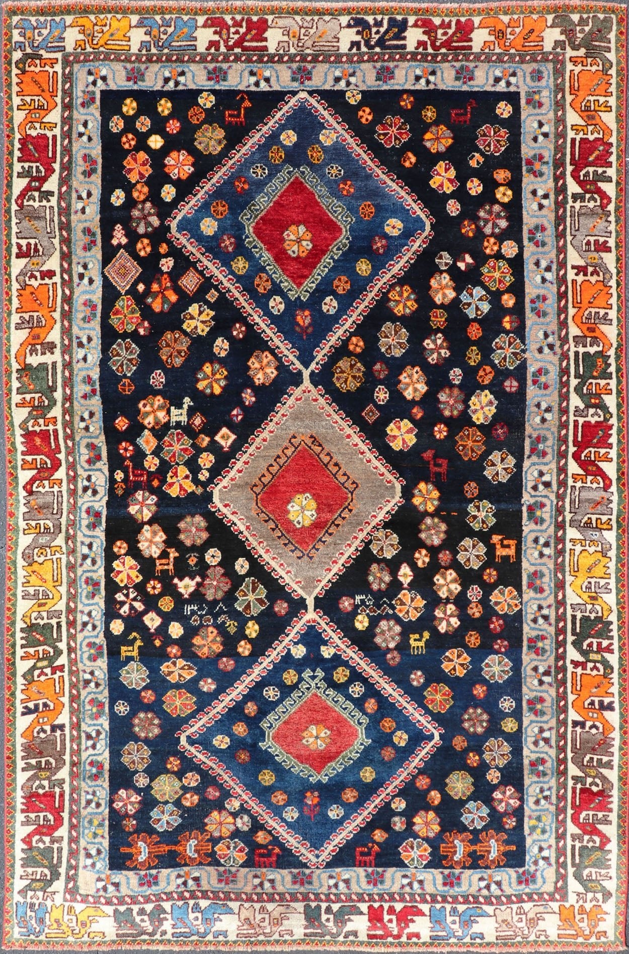 Vintage Persian Tribal Shiraz with Medallion Design on Dark Background This vintage Persian Shiraz features a rich navy blue background under the centered red medallions, edged with green, gold, taupe, maroon, pinks and reds. Paired with ea... - Keivan Woven ArtsEMB - 9694 - P13894 - 16510Rug