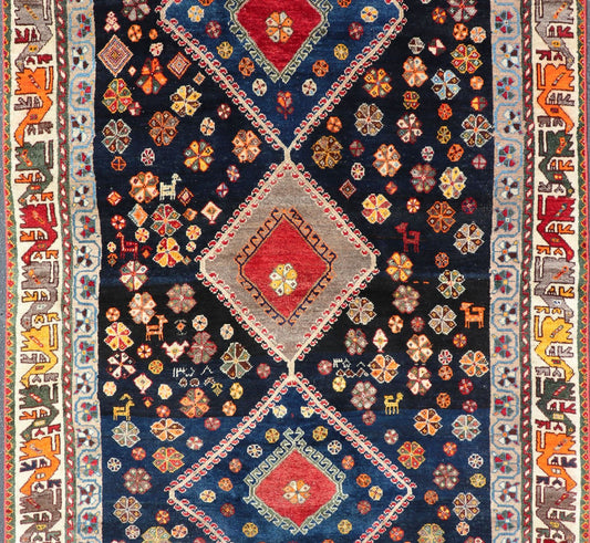 Vintage Persian Tribal Shiraz with Medallion Design on Dark Background This vintage Persian Shiraz features a rich navy blue background under the centered red medallions, edged with green, gold, taupe, maroon, pinks and reds. Paired with ea... - Keivan Woven ArtsEMB - 9694 - P13894 - 16510Rug