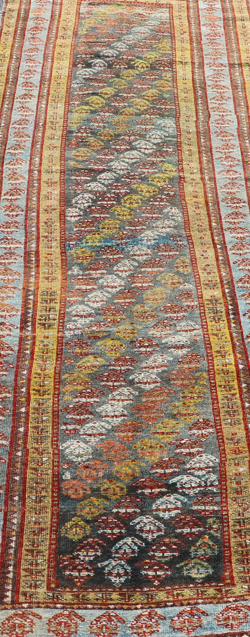 Antique Persian Hand - Knotted Kurdish Runner in Wool with Sub - Geometric Design This antique Persian Kurdish runner has been hand - knotted in wool and features an all - over sub - geometric design rendered in multicolor. A complementary, multi - tiered... - Keivan Woven ArtsEMB - 9698 - P13888 - 16540Rug