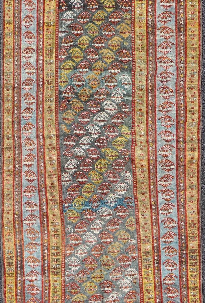 Antique Persian Hand - Knotted Kurdish Runner in Wool with Sub - Geometric Design This antique Persian Kurdish runner has been hand - knotted in wool and features an all - over sub - geometric design rendered in multicolor. A complementary, multi - tiered... - Keivan Woven ArtsEMB - 9698 - P13888 - 16540Rug