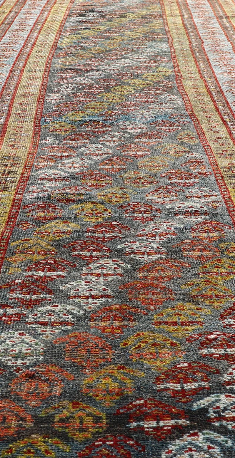 Antique Persian Hand - Knotted Kurdish Runner in Wool with Sub - Geometric Design This antique Persian Kurdish runner has been hand - knotted in wool and features an all - over sub - geometric design rendered in multicolor. A complementary, multi - tiered... - Keivan Woven ArtsEMB - 9698 - P13888 - 16540Rug
