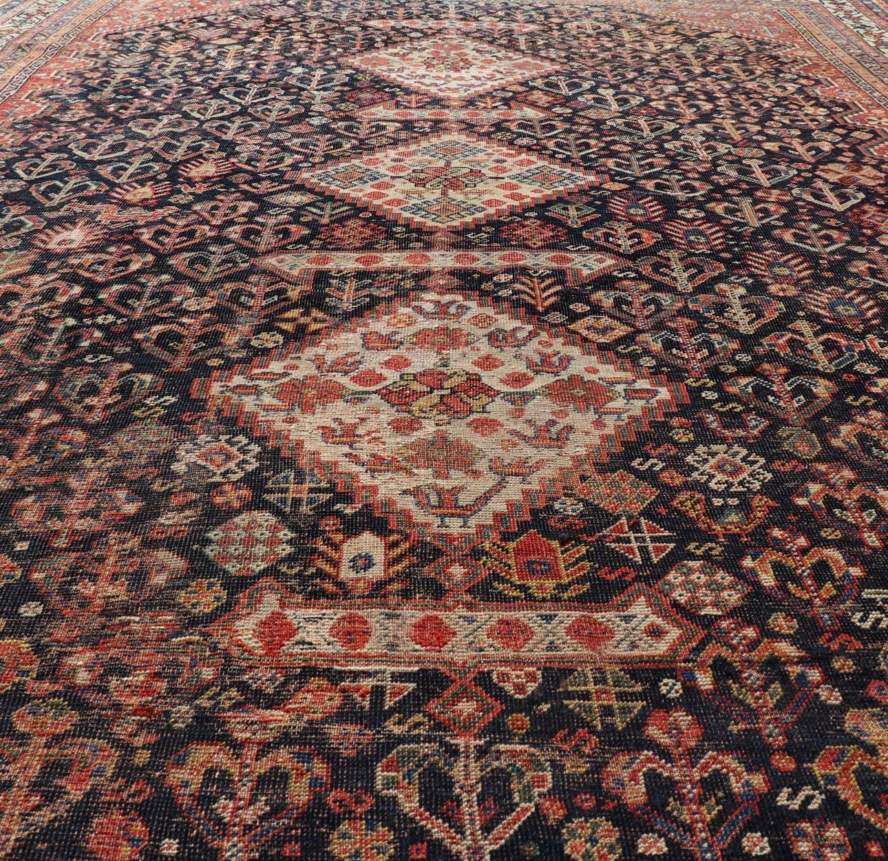 Measures: 7'1 x 9'9 Antique Persian Shiraz with All - Over Medallion Design in Ink Blue and Red. Keivan Woven Arts; rug EMB - 9703 - 13459, country of origin / type: Iran / Shiraz, circa 1920. This antique Persian Shiraz rug has been hand - knotted ... - Keivan Woven ArtsEMB - 9703 - 13459 - 16430Rug