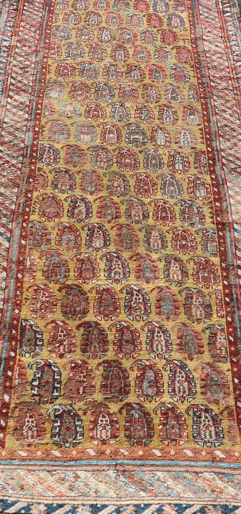 Antique Caucasian Kazak Runner with Paisley Design. Keivan Woven Arts; rug/ EMBC - 9617 - 13852 / Persian Rug, Country of Origin: Caucasus Type: Kazak Design: All - Over, Sub - Geometric, Kazak in Paisley design Measures: 3'6 x 8'3 This gorgeous ye... - Keivan Woven ArtsEMBC - 9617 - 13852 - 15947Rug