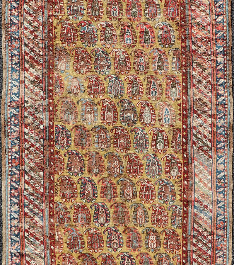 Antique Caucasian Kazak Runner with Paisley Design. Keivan Woven Arts; rug/ EMBC - 9617 - 13852 / Persian Rug, Country of Origin: Caucasus Type: Kazak Design: All - Over, Sub - Geometric, Kazak in Paisley design Measures: 3'6 x 8'3 This gorgeous ye... - Keivan Woven ArtsEMBC - 9617 - 13852 - 15947Rug