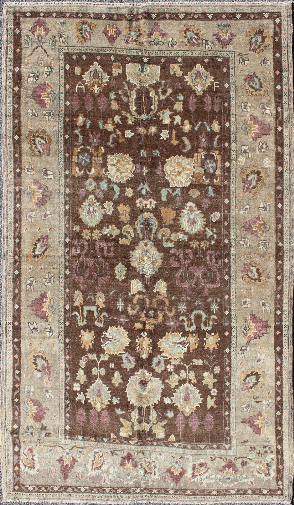 Vintage Turkish Oushak Rug in Brown Background with All - Over Floral Design Measures: 4'5 x 8'3 This Turkish Oushak is set on a chocolate - brown background and features a light gray/taupe border. The overall palette remains cool, with accent colors... - Keivan Woven ArtsEN - 1025 - 3844Rug