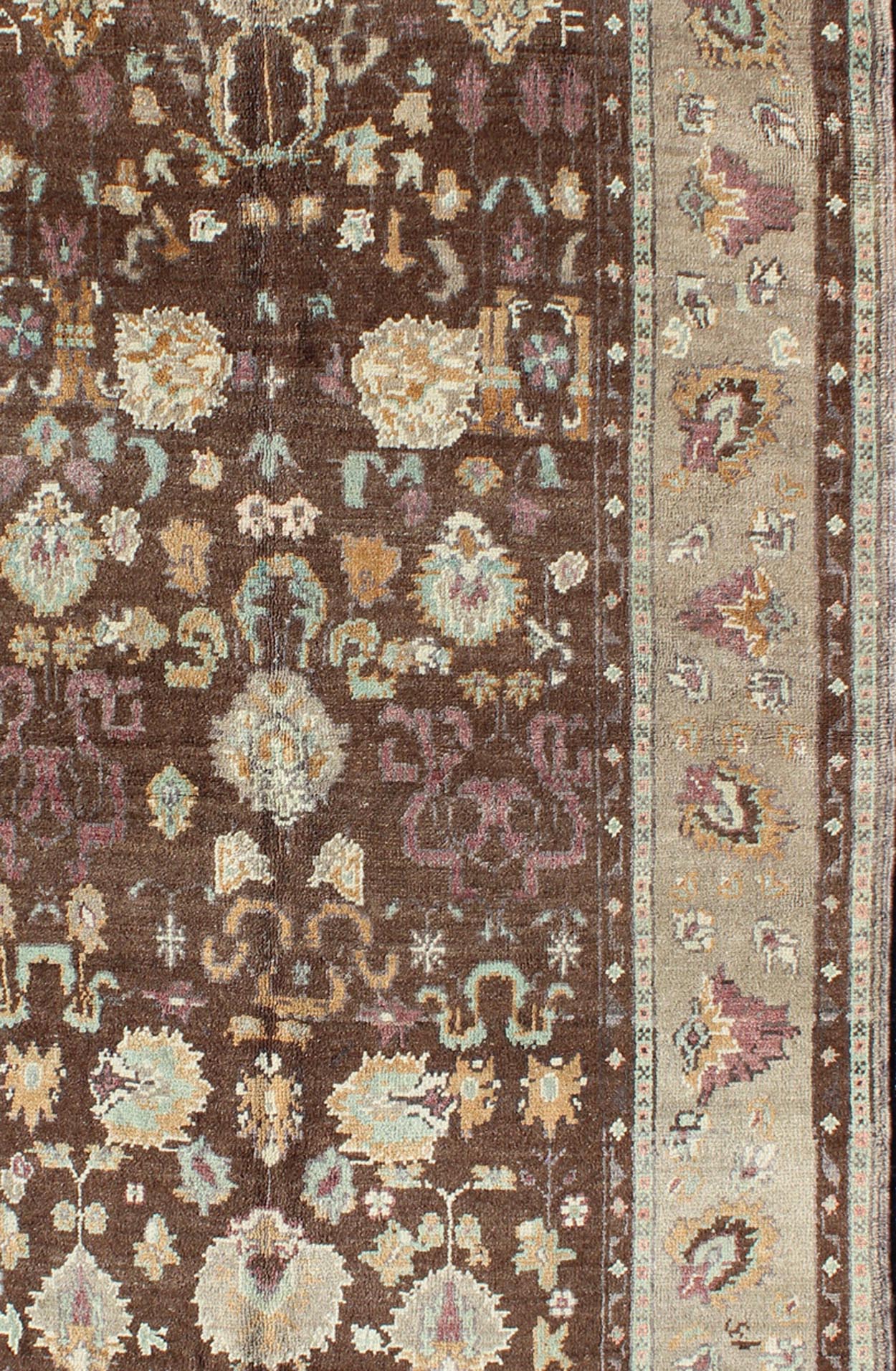 Vintage Turkish Oushak Rug in Brown Background with All - Over Floral Design Measures: 4'5 x 8'3 This Turkish Oushak is set on a chocolate - brown background and features a light gray/taupe border. The overall palette remains cool, with accent colors... - Keivan Woven ArtsEN - 1025 - 3844Rug