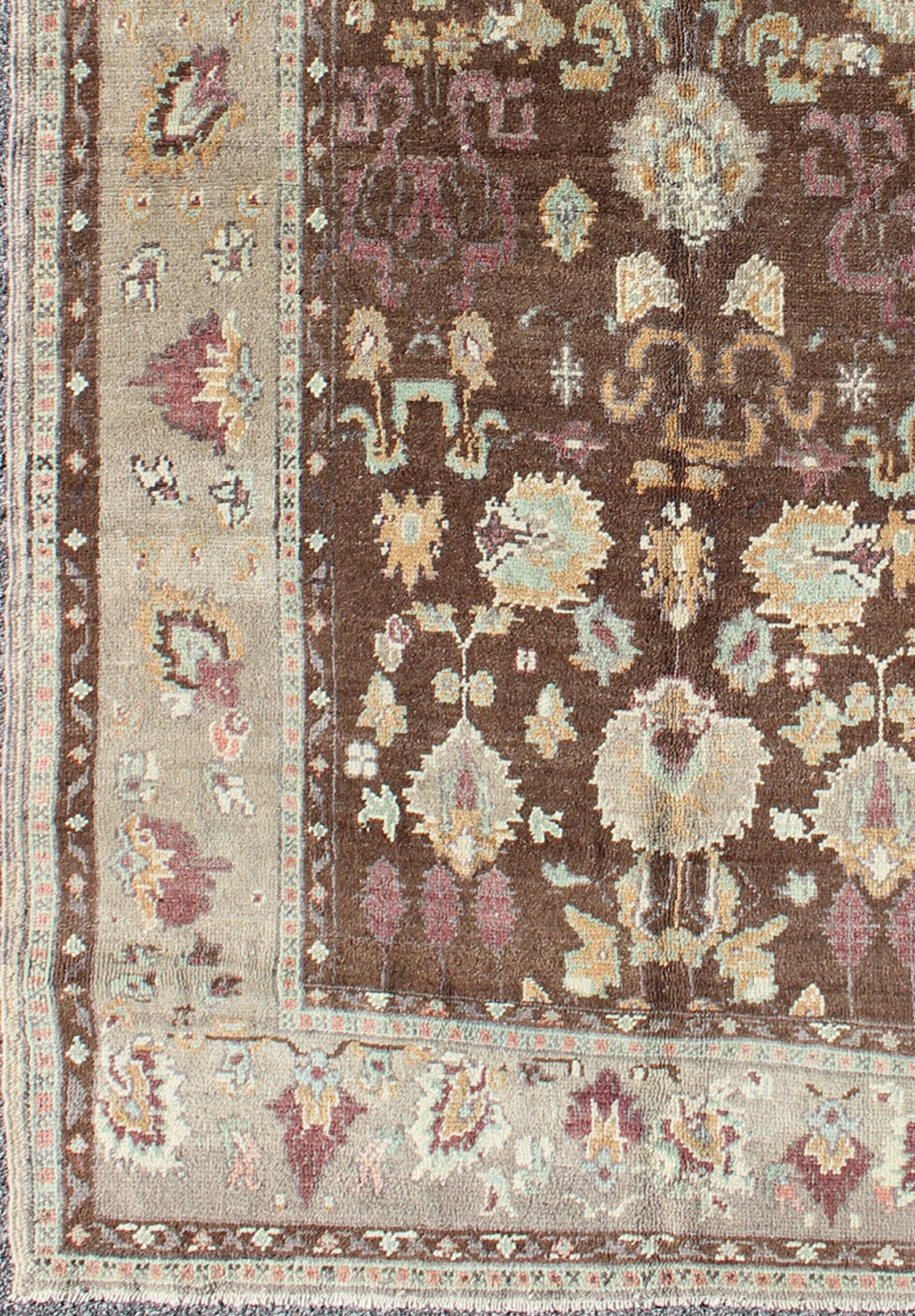Vintage Turkish Oushak Rug in Brown Background with All - Over Floral Design Measures: 4'5 x 8'3 This Turkish Oushak is set on a chocolate - brown background and features a light gray/taupe border. The overall palette remains cool, with accent colors... - Keivan Woven ArtsEN - 1025 - 3844Rug