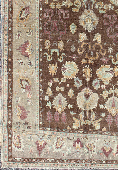 Vintage Turkish Oushak Rug in Brown Background with All - Over Floral Design Measures: 4'5 x 8'3 This Turkish Oushak is set on a chocolate - brown background and features a light gray/taupe border. The overall palette remains cool, with accent colors... - Keivan Woven ArtsEN - 1025 - 3844Rug