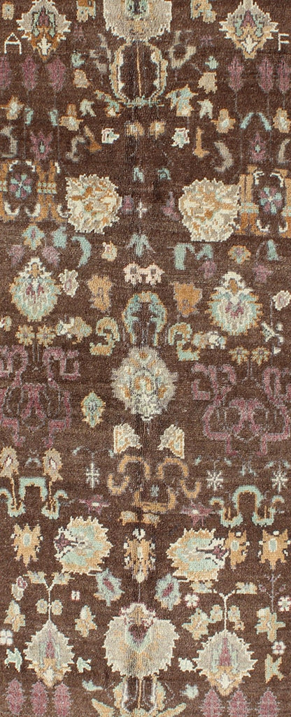 Vintage Turkish Oushak Rug in Brown Background with All - Over Floral Design Measures: 4'5 x 8'3 This Turkish Oushak is set on a chocolate - brown background and features a light gray/taupe border. The overall palette remains cool, with accent colors... - Keivan Woven ArtsEN - 1025 - 3844Rug