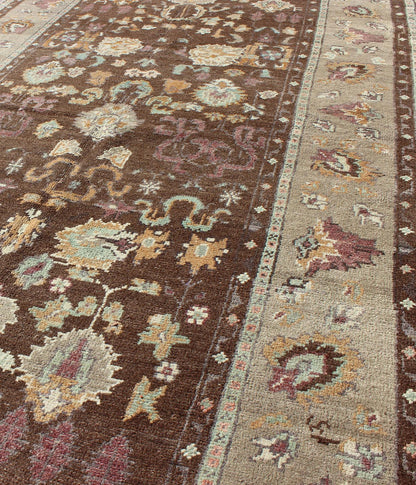 Vintage Turkish Oushak Rug in Brown Background with All - Over Floral Design Measures: 4'5 x 8'3 This Turkish Oushak is set on a chocolate - brown background and features a light gray/taupe border. The overall palette remains cool, with accent colors... - Keivan Woven ArtsEN - 1025 - 3844Rug