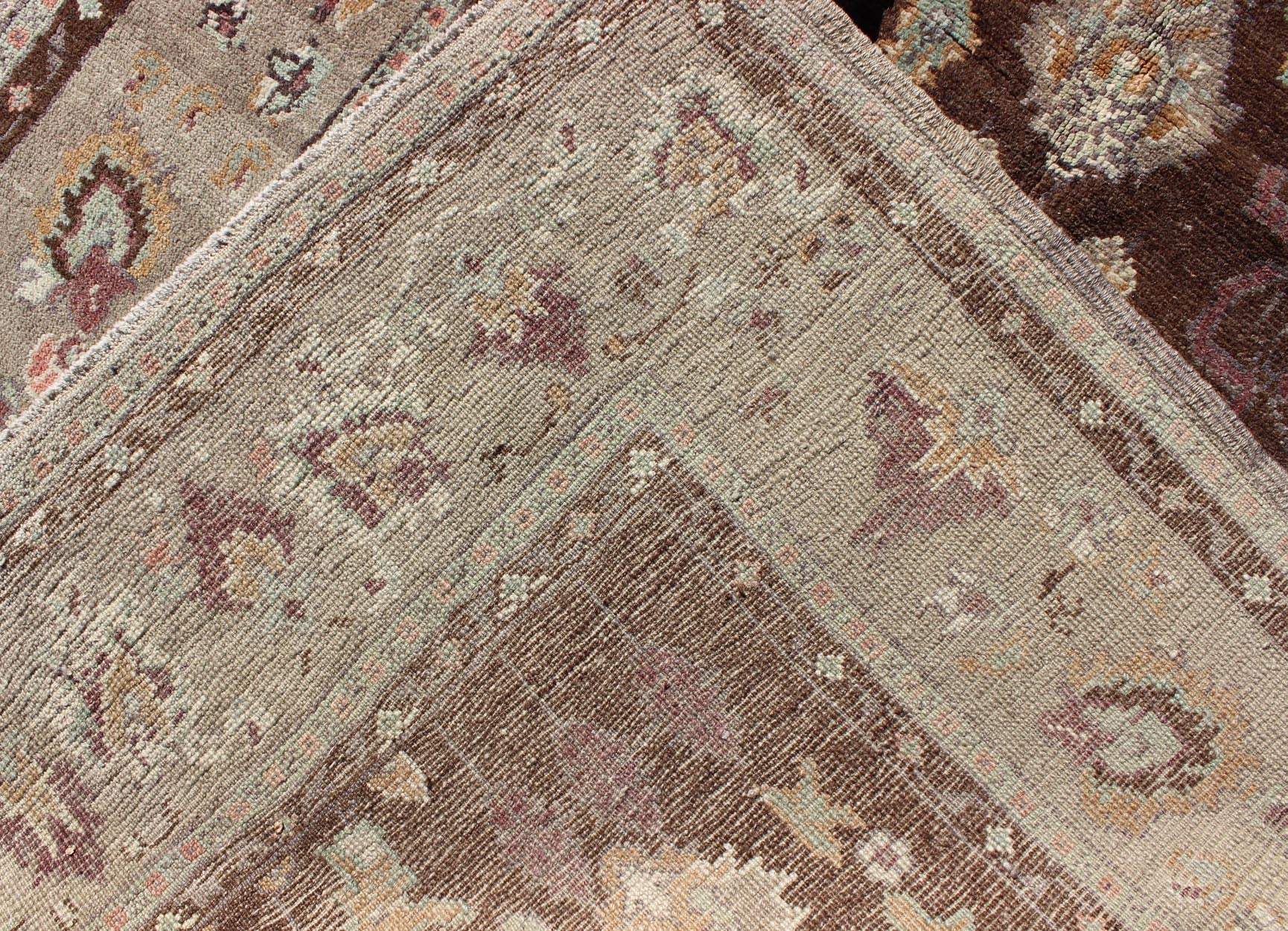 Vintage Turkish Oushak Rug in Brown Background with All - Over Floral Design Measures: 4'5 x 8'3 This Turkish Oushak is set on a chocolate - brown background and features a light gray/taupe border. The overall palette remains cool, with accent colors... - Keivan Woven ArtsEN - 1025 - 3844Rug
