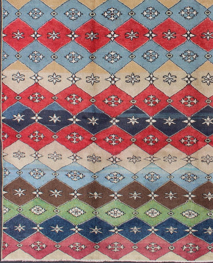 Mid - Century Rug Rendered with a multi - colored background and a spotted and speckled assortment of yellow, blue, green, red and brown colors, this very unique Mid Century rug has diamonds shapes that vary in color. Measures: 6`6 x 9` - Keivan Woven ArtsEN - 11037 - 5275Rug